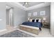 Main bedroom with plush carpet and built-in bench at the foot of the bed at 10985 Trevino St, Englewood, FL 34223