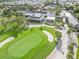 Aerial view of community clubhouse, golf course, and surrounding landscape at 10985 Trevino St, Englewood, FL 34223