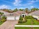Beautiful two-story home with three car garage and manicured lawn at 12424 Davie Ct, Venice, FL 34293