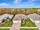 Single-Gathering home with a three-car garage and manicured lawn at 12424 Davie Ct, Venice, FL 34293