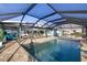 Enjoy this screened-in pool and spacious patio area at 12596 Bacchus Rd, Port Charlotte, FL 33981