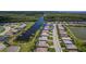 Aerial view highlighting waterfront homes in a community with canal access, and manicured lawns at 15048 Spanish Point Dr, Port Charlotte, FL 33981