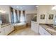 Luxurious bathroom with double vanity sinks, soaking tub, and a glass-enclosed walk-in shower at 15048 Spanish Point Dr, Port Charlotte, FL 33981