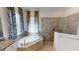 Bright bathroom with an elegant soaking tub and a glass enclosed shower at 15048 Spanish Point Dr, Port Charlotte, FL 33981