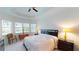 Bright bedroom featuring a ceiling fan, bay window, tray ceiling, and neutral color scheme at 15048 Spanish Point Dr, Port Charlotte, FL 33981