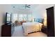Bright bedroom features a tray ceiling, large windows and plush carpeting at 15048 Spanish Point Dr, Port Charlotte, FL 33981
