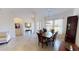 Open-concept dining room with a wood table, stylish chandelier, and natural light at 15048 Spanish Point Dr, Port Charlotte, FL 33981