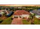 Beautiful single Gathering home features a tile roof, paver driveway, and two car garage at 15048 Spanish Point Dr, Port Charlotte, FL 33981