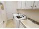 Functional laundry room with modern appliances, ample storage, and granite countertops at 15048 Spanish Point Dr, Port Charlotte, FL 33981