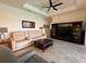Spacious living room with tile floors, ceiling fan, and entertainment center at 15048 Spanish Point Dr, Port Charlotte, FL 33981