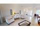 Bright living room with tile floors, white furniture, and lots of natural light at 15048 Spanish Point Dr, Port Charlotte, FL 33981