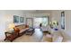 Bright living room area with tile floors and neutral-colored furniture at 15048 Spanish Point Dr, Port Charlotte, FL 33981