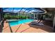 Outdoor patio featuring comfortable seating, a poolside view, and a relaxing atmosphere at 15048 Spanish Point Dr, Port Charlotte, FL 33981