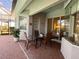Charming patio area with brick flooring, neutral colors, and dining set perfect for outdoor entertaining at 15048 Spanish Point Dr, Port Charlotte, FL 33981
