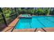 A private screened-in pool and spa with red brick surround and lush, tropical landscaping at 15048 Spanish Point Dr, Port Charlotte, FL 33981