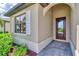 Front entry with arched detail and dark brown door at 1993 E Isles Rd, Port Charlotte, FL 33953