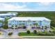 Aerial view of the light blue multi-unit building and parking lot at 3929 Cape Haze Dr # 105, Rotonda West, FL 33947