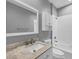 Clean, simple bathroom with white tile, marble countertop, and bathtub at 3929 Cape Haze Dr # 105, Rotonda West, FL 33947