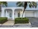 Exterior view of townhome units with garages, walkways, and landscaping at 3929 Cape Haze Dr # 105, Rotonda West, FL 33947