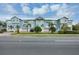 Front view of light blue townhouses with attached garages at 3929 Cape Haze Dr # 105, Rotonda West, FL 33947
