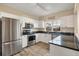 Modern kitchen with white cabinets, dark countertops, and stainless steel appliances at 3929 Cape Haze Dr # 105, Rotonda West, FL 33947
