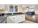 Kitchen with dark countertops, white cabinets, and view of living area at 3929 Cape Haze Dr # 105, Rotonda West, FL 33947