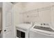 Laundry room with washer, dryer, and ample shelving at 3929 Cape Haze Dr # 105, Rotonda West, FL 33947