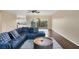 Living room featuring a blue sectional sofa, wood floors, and access to a balcony at 3929 Cape Haze Dr # 105, Rotonda West, FL 33947