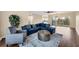 Living room with blue sectional, wood floors, ceiling fan, and view of the balcony at 3929 Cape Haze Dr # 105, Rotonda West, FL 33947