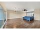 Spacious living room with blue sectional sofa, wood floors, and sliding glass door to balcony at 3929 Cape Haze Dr # 105, Rotonda West, FL 33947