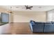 Living area with blue couch, ceiling fan, wood-look floors, and sliding glass doors at 3929 Cape Haze Dr # 105, Rotonda West, FL 33947