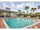 Community pool with covered patio and plenty of lounge chairs at 3929 Cape Haze Dr # 105, Rotonda West, FL 33947