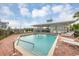 Refreshing community pool with surrounding patio and lounge chairs at 3929 Cape Haze Dr # 105, Rotonda West, FL 33947