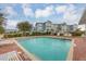Relaxing community pool area with patio and lounge chairs near building at 3929 Cape Haze Dr # 105, Rotonda West, FL 33947