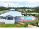 Community pool and covered patio with picnic tables at 3929 Cape Haze Dr # 105, Rotonda West, FL 33947
