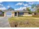 Single story home with attached garage and yard at 400 Bluebell Rd, Venice, FL 34293