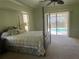 Main bedroom with a large bed, pool view, and ceiling fan at 5160 Farewell St, Port Charlotte, FL 33981