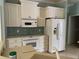 Well-equipped kitchen with white cabinets and tile backsplash at 5160 Farewell St, Port Charlotte, FL 33981