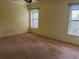 Bright bedroom with neutral walls, carpet flooring, and two windows at 5160 Farewell St, Port Charlotte, FL 33981
