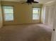 Spacious bedroom with ceiling fan, carpet flooring, and double-door closet at 5160 Farewell St, Port Charlotte, FL 33981