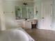 Bathroom with a large vanity, bathtub, and tile floor at 5160 Farewell St, Port Charlotte, FL 33981