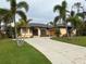 Single-story home with a two-car garage and attractive landscaping at 5160 Farewell St, Port Charlotte, FL 33981