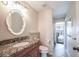 Bathroom with granite vanity and shower access at 9381 St Paul Dr, Port Charlotte, FL 33981