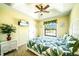 Bedroom with leafy bedding and a view of the backyard at 9381 St Paul Dr, Port Charlotte, FL 33981