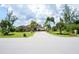 Single-story house with palm trees and a paved driveway at 9381 St Paul Dr, Port Charlotte, FL 33981