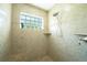 Large tiled shower with built-in seat at 9381 St Paul Dr, Port Charlotte, FL 33981