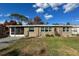 Tan house with screened porch and landscaped yard at 1530 Phillip Pl, Englewood, FL 34223