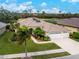 Aerial view of single-Gathering home with solar panels and two-car garage at 5100 White Ibis Dr, North Port, FL 34287