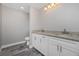 Bathroom with granite countertop, white cabinets, and tile floor at 148 Lime Tree Park, Rotonda West, FL 33947