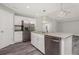 Modern kitchen with island and stainless steel appliances at 148 Lime Tree Park, Rotonda West, FL 33947
